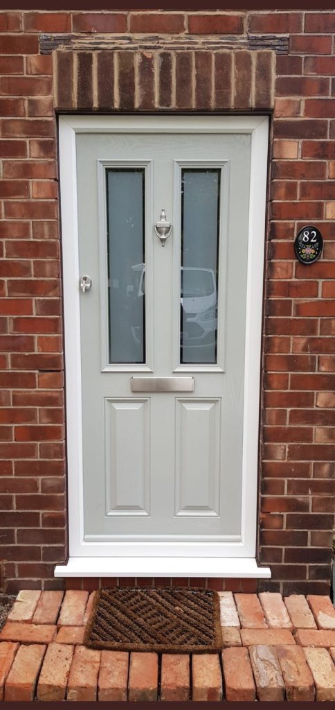 Finished composite front door replacement in UK home.