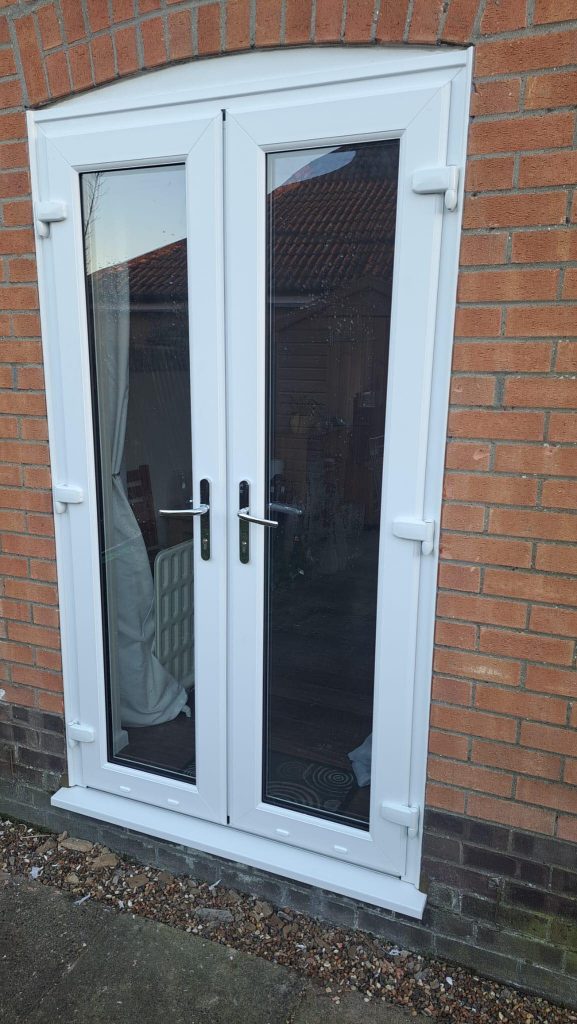 White uPVC back door with glass panel providing secure access to garden.