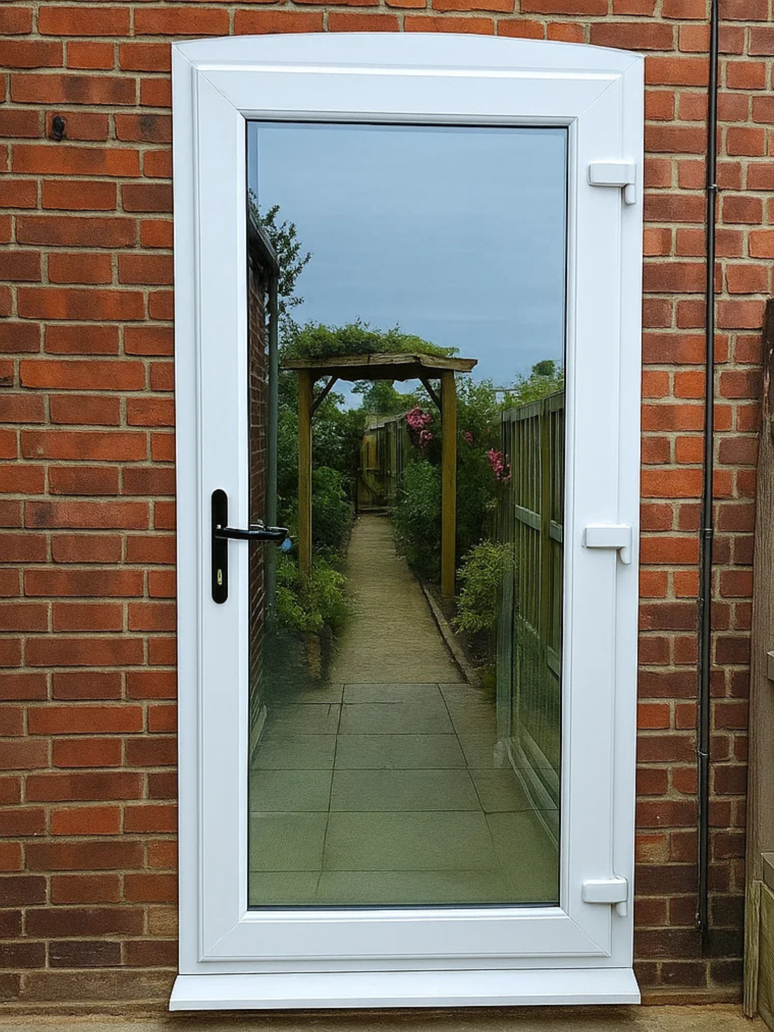 Modern uPVC back door with full-height glazed panel opening to garden